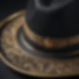 Close-up view of a black and gold fedora hat showcasing intricate craftsmanship