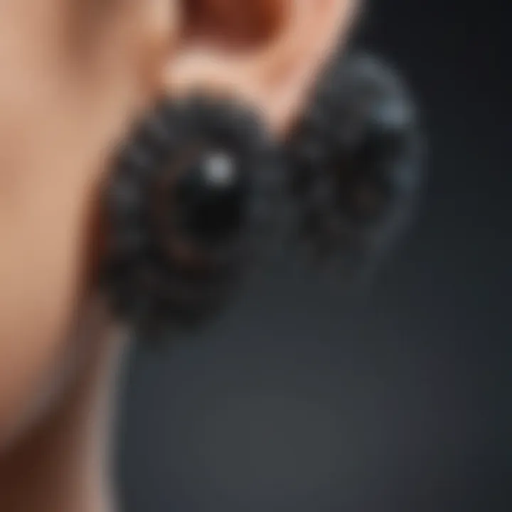 Various styles of black cubic zirconia stud earrings arranged artistically.